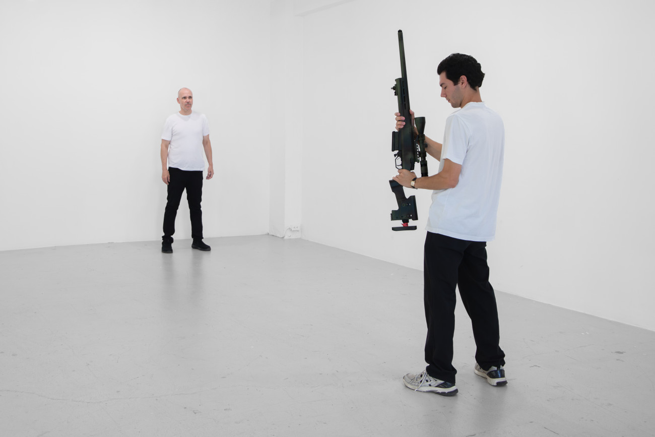 Steve Giasson. Performance invisible n&deg; 291 (Jouer &agrave; la guerre). Reenactment de Chris Burden. Shoot. 1971. Performeurs : Steve Giasson et F&eacute;lix Hould. Cr&eacute;dit photographique et vid&eacute;ographique : Martin Vinette. Retouches photographiques&nbsp;et vid&eacute;ographiques : Charles-&Eacute;tienne Lebrun. Galerie B-312. 15 ao&ucirc;t 2025.